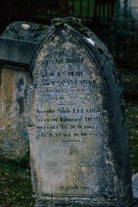 Close-up of text on stone at cemetery