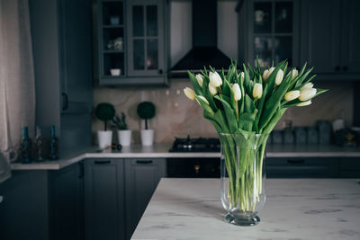 Close-up of flower vase on table at home