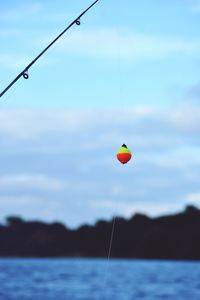 Low angle view of fishing net on sea against sky