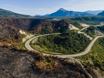 High angle view of road amidst mountains against sky