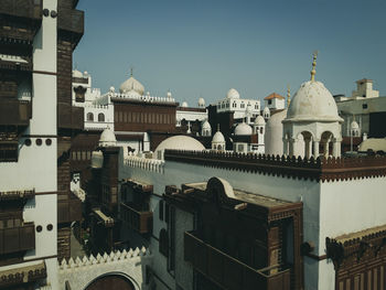 Buildings in city against clear sky