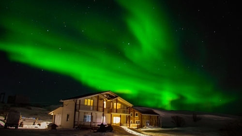 Illuminated building against sky at night