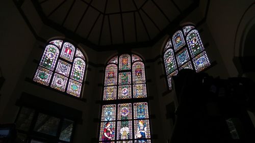 Low angle view of stained glass window in building