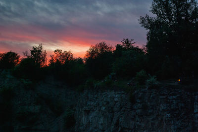 Low angle view of silhouette trees against sky at sunset