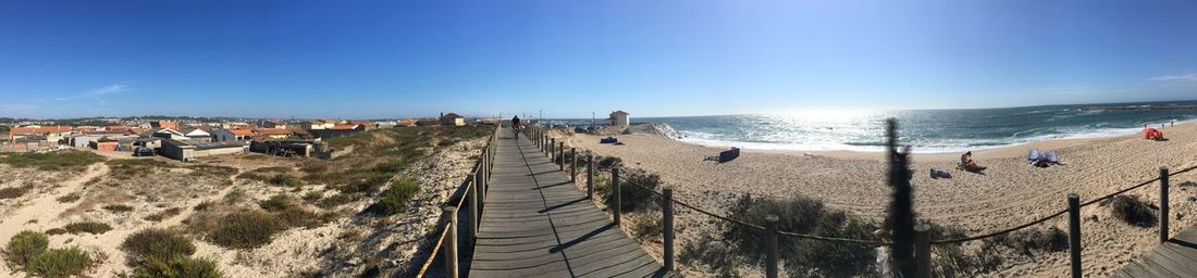 Panoramic view of beach against blue sky