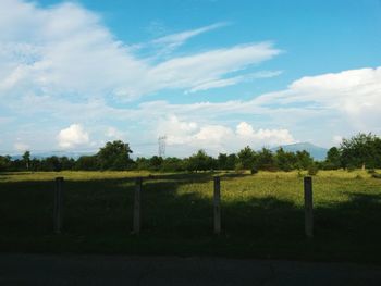 Scenic view of field against cloudy sky