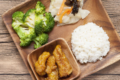 High angle view of meal served in plate on wooden table