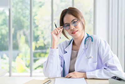 Young businesswoman working at table