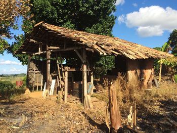 Abandoned house on field against sky