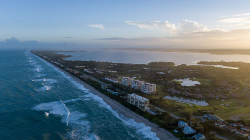 High angle view of buildings by sea against sky