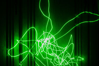 Long exposure abstract photo of a green laser