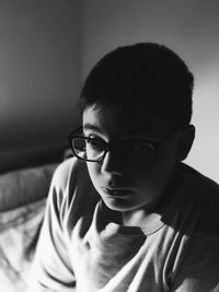 Close-up of boy wearing eyeglasses at home