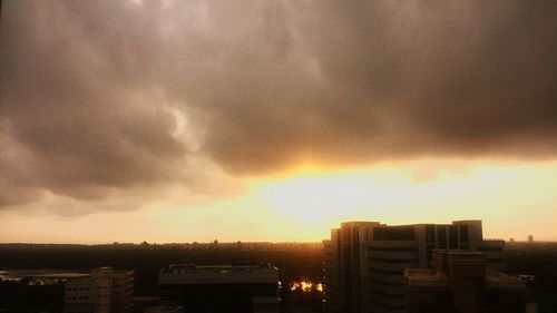 Cityscape against cloudy sky