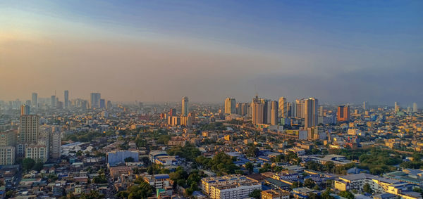 High angle view of modern buildings in city against sky