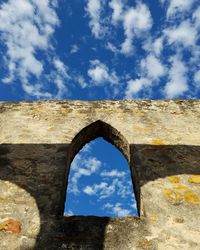 Low angle view of blue sky seen through arch