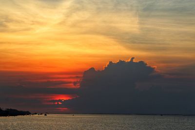 Scenic view of sea against dramatic sky during sunset