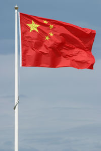 Low angle view of flag against sky