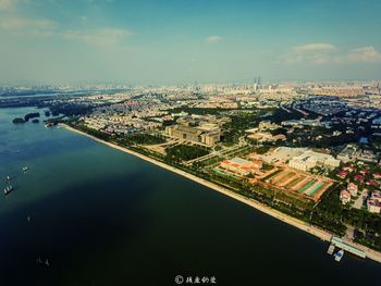 Aerial view of calm sea against cityscape