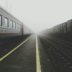 Train on railroad tracks against clear sky