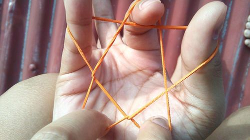 Cropped hands holding rubber band