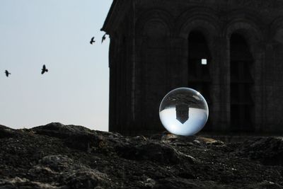 Upside down building seen through crystal ball