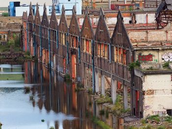 Houses by river in town