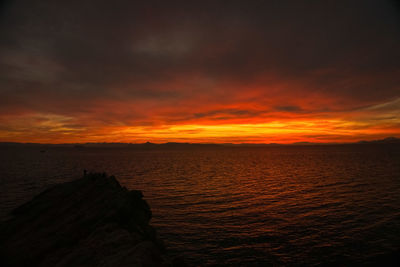 Scenic view of sea against orange sky