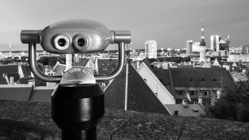 Coin-operated binocular against cityscape