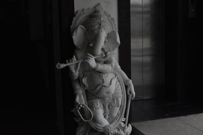 Midsection of child statue at home