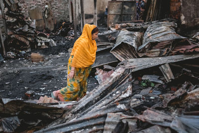 Woman walking in metal scrap