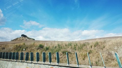 Scenic view of landscape against blue sky