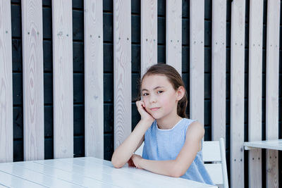 Portrait of girl sitting at table