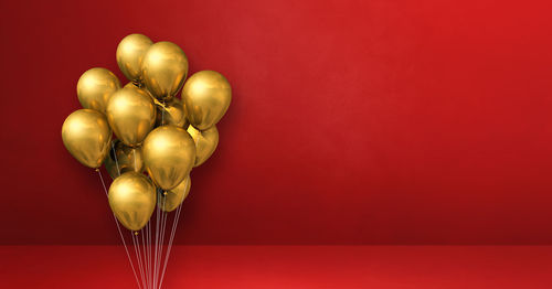 Heart shaped balloons against red background