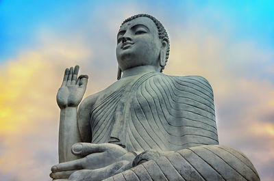 Low angle view of statue against sky