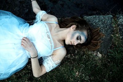 High angle view of woman lying on field