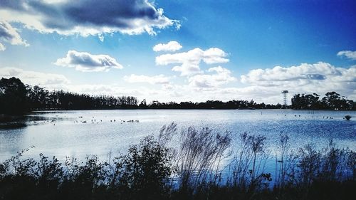 Scenic view of lake against cloudy sky