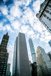 Low angle view of modern building against cloudy sky