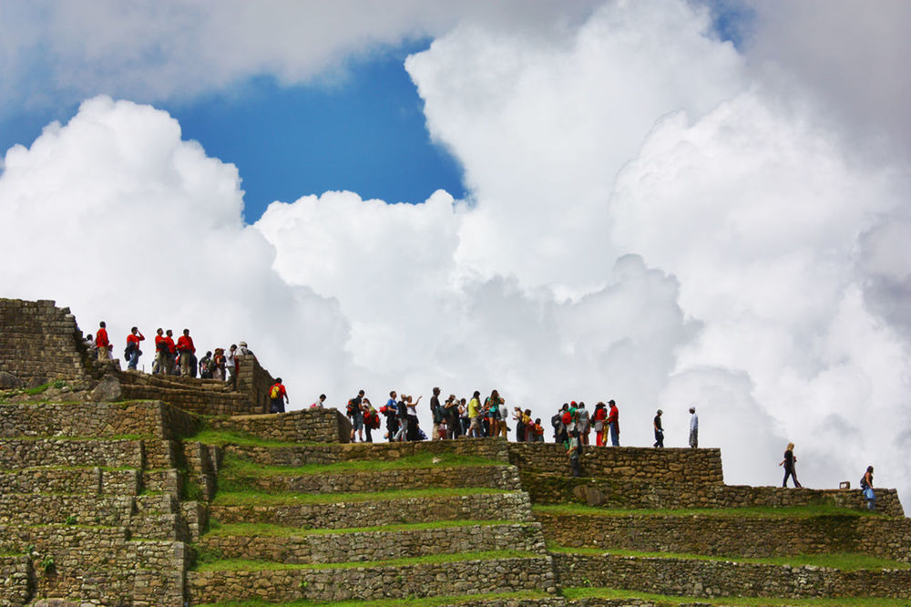 LOW ANGLE VIEW OF PEOPLE IN PARK AGAINST SKY