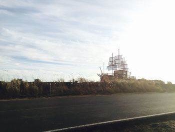 Road by built structure against sky