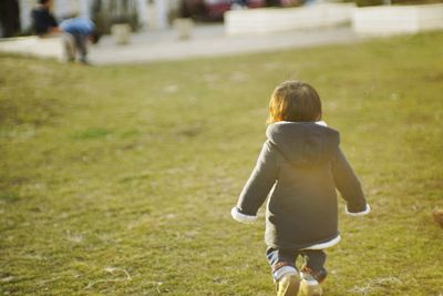 Rear view of girl on grass