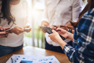 Midsection of woman using mobile phone