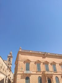 Low angle view of building against clear blue sky