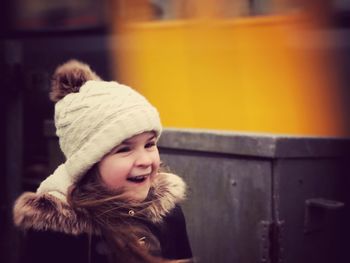 Happy girl wearing warm clothing looking away