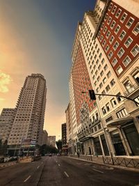 City street and buildings against sky