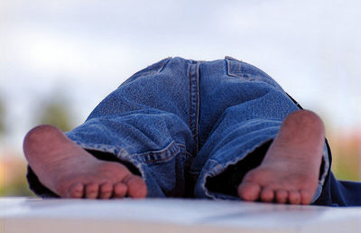 Low section of child lying on table