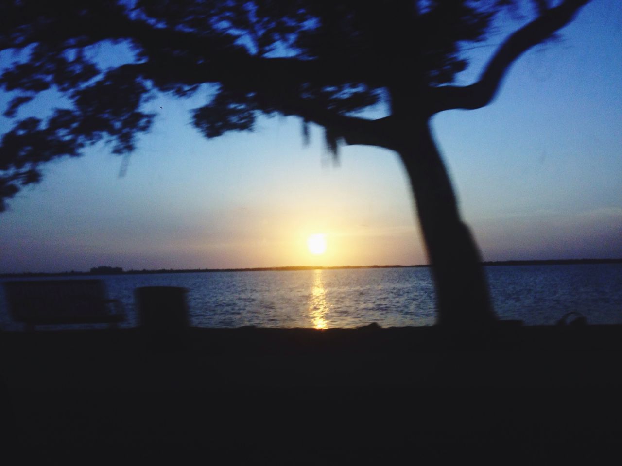 sunset, water, sun, tranquil scene, silhouette, tranquility, sea, scenics, beauty in nature, horizon over water, sky, nature, tree, reflection, sunlight, idyllic, lake, orange color, calm, branch