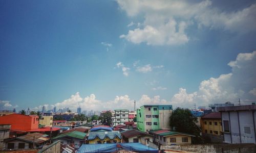 Cityscape against cloudy sky