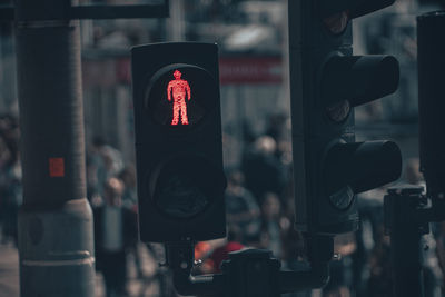 Close-up of red stoplight on a busy street