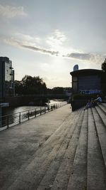 Scenic view of river by city against sky