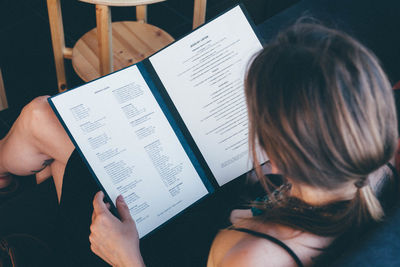 Cropped image of woman holding book